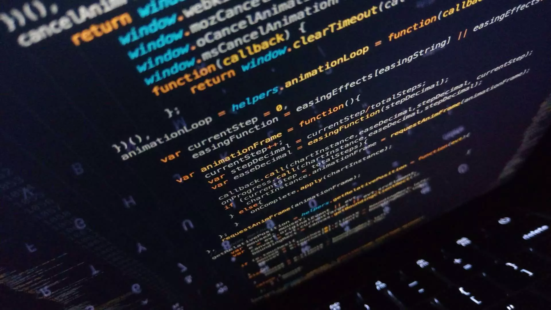 Computer code on a partially closed laptop screen. Photographed by Irvan Smith on Unsplash.